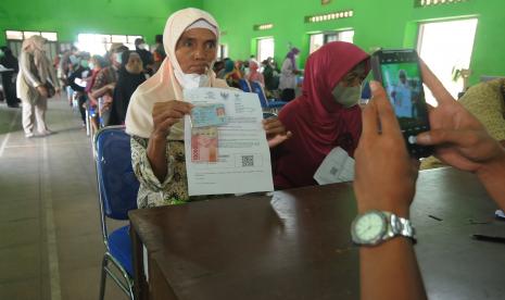 Warga menunjukan dokumen dan uang bantuan langsung tunai (BLT) saat pendokumentasian oleh petugas. (Ilustrasi)