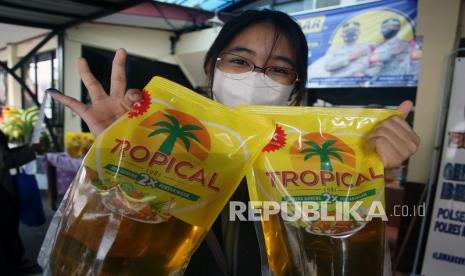 Warga menunjukkan minyak goreng dan jari yang sudah diberi tinta sebagai tanda sudah membeli minyak goreng saat berlangsungnya operasi pasar minyak goreng. Pemerintah Kabupaten (Pemkab) Sintang, Kalimantan Barat, meminta Kementerian Perdagangan (Kemendag) segera mengatasi kelangkaan minyak goreng di daerah.