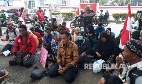 Warga Pulau Pari berdoa bersama di depan Kantor Ombudsman RI, Jalan HR Rasuna Said, Jakarta Selatan, Senin (9/4). 