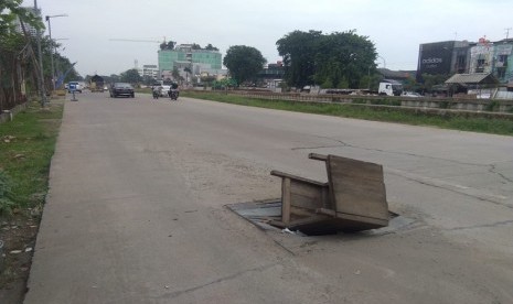 Warga sengaja menutupi gorong-gorong dengan meja kayu di Jalan Raya Kalimalang