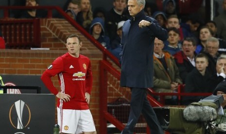 Wayne Rooney (kiri) menunggu instruksi Jose Mourinho sebelum masuk pada babak kedua laga Grup A Liga Europa lawan Zorya, Jumat (30/9) dini hari WIB. Pada laga yang digelar di Old Trafford itu, United menang 1-0.