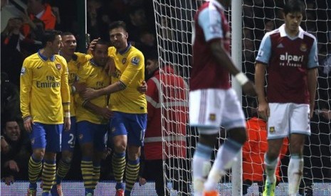 Winger Arsenal, Theo Walcott (tiga kiri), melakukan selebrasi bersama rekan setimnya usai menjebol gawang West Ham United dalam laga Liga Primer Inggris di Boleyn Ground, London, Kamis (26/12). 