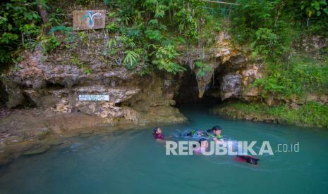 Wisatawan berenang di goa Liang Tapah di Desa Geragata, Kabupaten Tabalong, Kalimantan Selatan, Ahad (27/12/2020). Goa Liang Tapah merupakan salah satu wisata alam yang termasuk geosite di wilayah Geopark Meratus di Provinsi Kalimantan Selatan yang ramai dikunjungi wisatawan saat hari libur. 