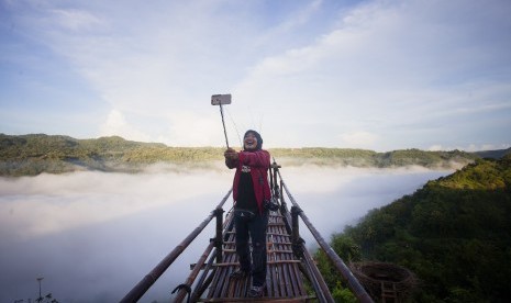 Wisatawan berswafoto di kawasan wisata Bukit Mojo, Gumelem, Dlingo, Bantul, DI Yogyakarta, Minggu (2/4). 