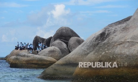 Wisatawan menikmati keindahan di Pantai Tanjung Tinggi, Belitung, Kamis (10/3).