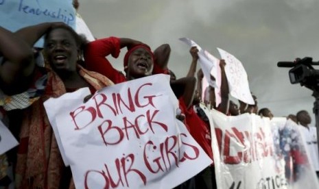 Women react during a protest demanding security forces search harder for 200 schoolgirls abducted by Boko Haram two weeks ago in Abuja April 30, 2014.