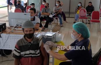 Petugas kesehatan menyuntikkan vaksin COVID-19 dosis ketiga kepada seorang penumpang bus saat vaksinasi massal di Terminal Tipe A Mengwi, Badung, Bali, Senin (25/2/2022). Ratusan penumpang bus mengikuti vaksinasi booster di terminal pada arus mudik Idul Fitri 1443 Hijriah untuk mendapatkan sertifikat vaksin dosis ketiga sebagai syarat perjalanan ke Pulau Jawa. 