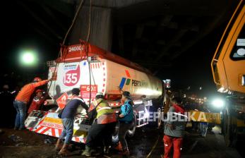 Proses evakuasi truk tangki bahan bakar minyak (BBM) yang menyebabkan kecelakaan dengan dengan sejumlah kendaraan di di Jalan Transyogi, Cibubur, Bekasi, Jawa Barat, Senin (18/7/2022). Proses evakuasi berjalan lancar dengan dibantu satu alat berat crane, satu mobil derek dan mobil pemadam kebakaran dengan cara memindahkan tanki dari truk yang ringsek ke truk yang berfungsi normal.Prayogi/Republika.