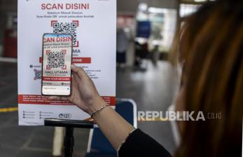 Calon penumpang memindai kode batang (QR Code) untuk menaiki KRL di Stasiun Manggarai, Jakarta, Senin (6/9). PT KAI Commuter mulai melakukan uji coba penggunaan aplikasi PeduliLindungi bagi pengguna KRL di 11 stasiun. Republika/Putra M. Akbar