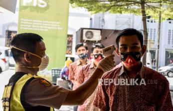 Petugas dari  Biddokkes Polda Jabar memeriksa suhu tubuh jamaah yang akan melaksanakan ibadah Sholat Jumat di Masjid Raya Bandung, Jalan Dalem Kaum, Kota Bandung, Jumat (12/6). Masjid Raya Bandung kembali menggelar sholat jumat dengan menerapkan protokol kesehatan dan jaga jarak fisik (physical distancing) antarsaf serta membatasi jumlah jamaah menjadi 30 persen dari kapasitas masjid
