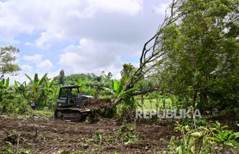 Prajurit TNI  menggunakan alat berat membersihkan kebun cengkeh milik Perhutani di Desa Sumber Mujur, Candipuro, Lumajang, Jawa Timur, Sabtu (18/12/2021). Pemerintah menyiapkan lahan seluas 81 hektare milik Perhutani sebagai tempat hunian sementara korban erupsi Gunung Semeru. 