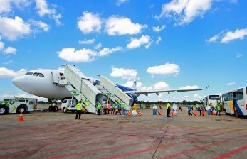 Sejumlah jamaah calon haji asal Hulu Sungai Selatan dan Banjarmasin berjalan memasuki pesawat saat keberangkatan kloter pertama di Bandara Syamsuddin Noor, Banjarbaru, Kalimantan Selatan, Selasa (9/7/2019). Calon Jamaah Haji Kalteng akan Berangkat 18 Juni dari Banjarmasin