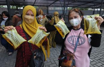 Warga menunjukkan minyak goreng yang dibeli saat pasar minyak goreng murah di Boyolali, Jawa Tengah, Senin (14/3/2022). Dinas Perdagangan dan Perindustrian Kabupaten Boyolali menggelar pasar minyak goreng murah untuk warga dengan harga jual Rp13.500 per liter dan diharapkan dapat membantu warga dalam kebutuhan minyak goreng karena di pasaran mahal dan sulit.