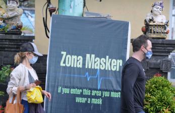 Warga negara asing (WNA) mengenakan masker saat berada di kawasan Kuta Utara, Badung, Bali, Rabu (10/3/2021). Gubernur Bali melalui Pergub Bali Nomor 10 tahun 2021 memperketat sanksi bagi WNA pelanggar protokol kesehatan COVID-19 dimana dalam peraturan sebelumnya sanksi berupa denda administratif sebesar Rp100.000 menjadi sanksi denda administratif sebesar satu juta rupiah untuk pelanggaran pertama dan sanksi deportasi bagi WNA yang melakukan dua kali pelanggaran prokes.