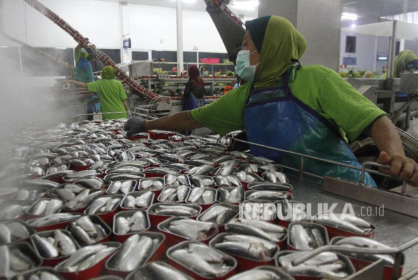 [ilustrasi] Seorang pekerja melakukan pengisian ikan dalam kaleng di pabrik sarden.