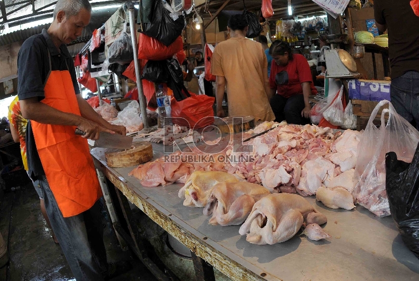 Pedagang ayam memotong ayam di salah satu lapak penjualan ayam potong di Pasar Senen, Jakarta, Selasa (11/8).   (Republika/Agung Supriyanto)