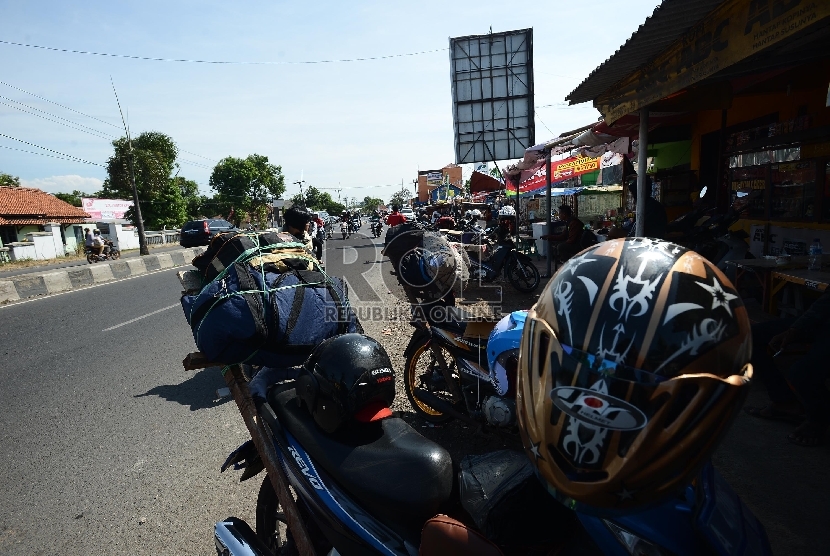 Pemudik motor beristirahat di rest area saat pulang ke kampung halamannya yang melintas di Kota Cirebon, Jawa Barat, Rabu (15/7). (Republika/Raisan Al Farisi)