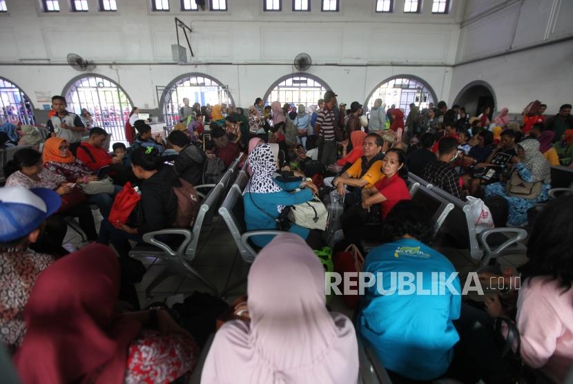 Suasana penumpang saat menunggu kereta api di Stasiun Pasar Senen, Jakarta, Selasa (26/12).