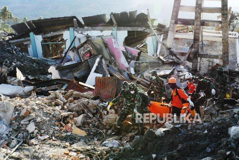 Anggota TNI dan anggota Basarnas, berhasil mengevakuasi jenazah korban yang tertimbun puing-puing reruntuhan di di perumnas Balaroa, Palu, Sulawesi Tengah, Senin (8/10).