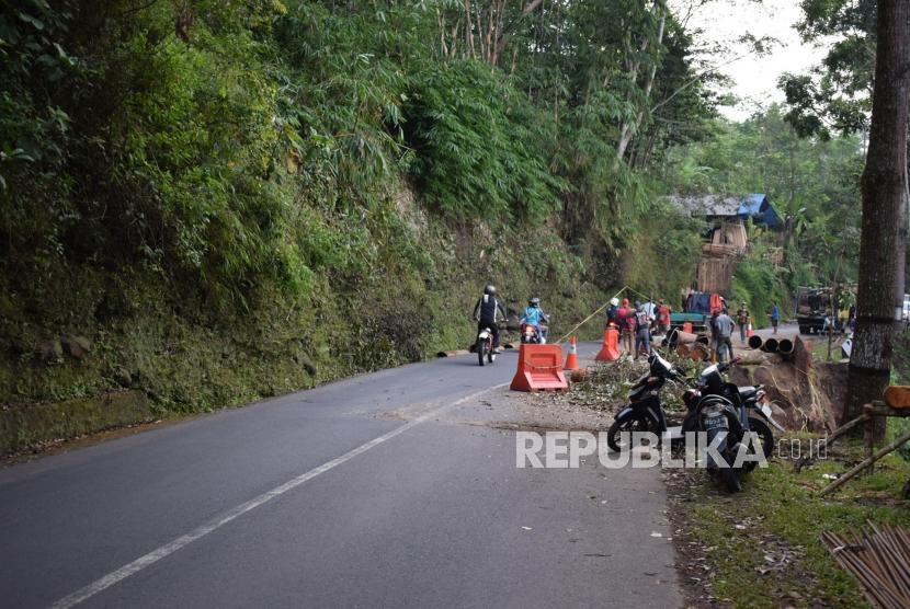 Sejumlah pekerja dari Dinas Bina Marga dan Penataan Ruang membenahi pinggiran jalan yang longsor di ruas jalan provinsi batas kabupaten Garut dan Tasikmalaya, di Kecamatan Singaparna, Kabupaten Tasikmalaya, Senin (28/5).