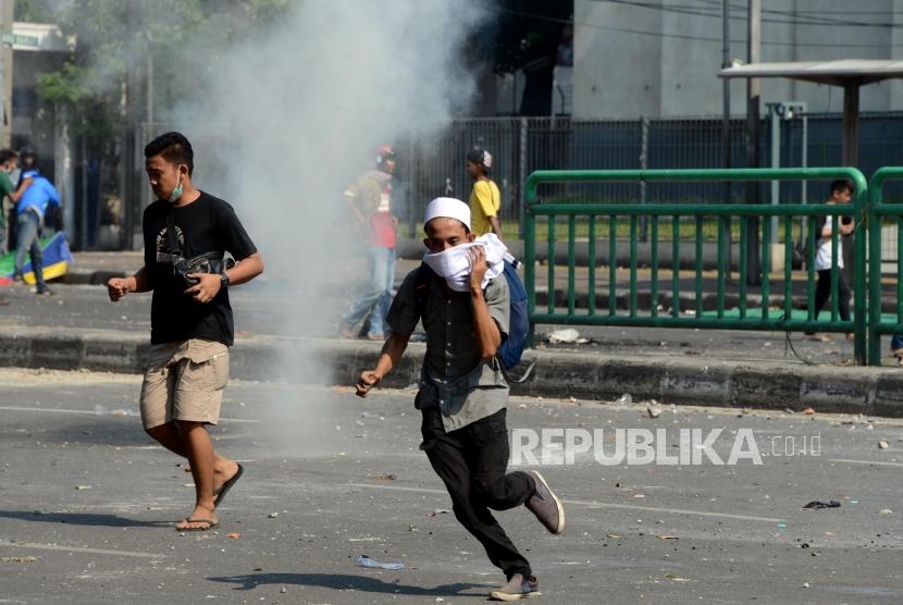 Sejumlah massa aksi saat behadapan dengan brimob di Jalan Jatibaru Raya, Tanah Abang, Jakarta, Rabu (22/5).