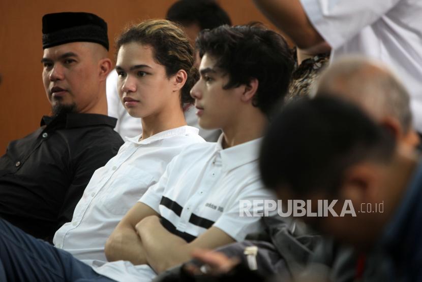 Musisi Ahmad Dhani (kiri) didampingi keduanya putranya Al Ghazali (kanan) dan Abdul Qodir Jaelani (tengah) bersiap menjalani sidang perdana kasus ujaran kebencian di Pengadilan Negeri Jakarta Selatan.
