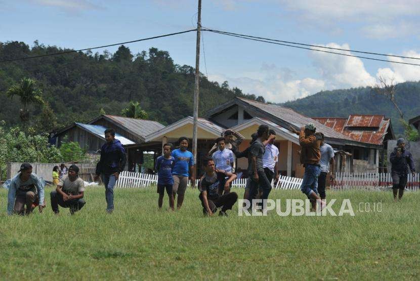 Bantuan Untuk Daerah Terisolir : Warga menunggu distibusi bantuan petugas TNI AD bersama PMI yang diangkut menggunakan helikopter TNI AD MI 17 di Desa Bolapapu, Kolawi, Kabupaten Sigi, Sulawesi Tengah, Senin (8/10).