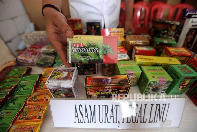 Petugas memperlihatkan obat ilegal saat rilis di Jalan Cemara, Kompleks Gading Griya Lestari, Jakarta, Jumat (21/9).