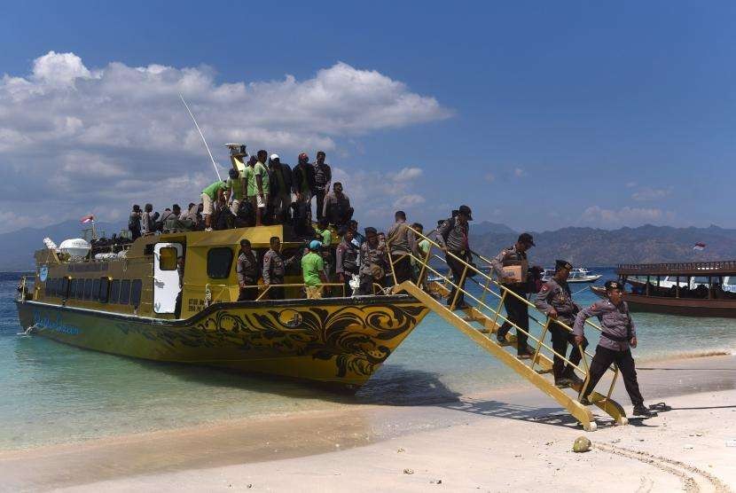 Sejumlah polisi menuruni kapal cepat setibanya di Gili Trawangan, Lombok Utara,  NTB, Kamis (9/8).