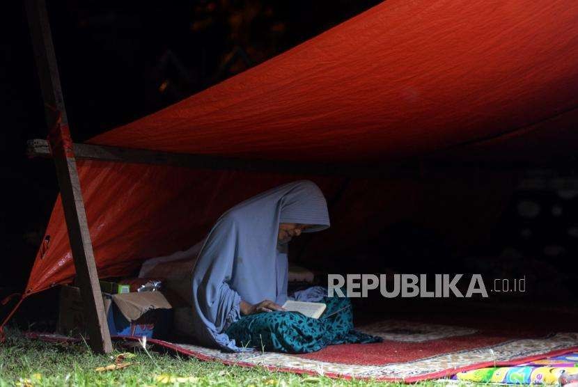 Sejumlah pengungsi korban bencana alam gempa bumi dan tsunami saat membaca Al Quran di Posko Pengungsian Rumah Dinas Gubernur, Palu, Sulawesi Selatan, Rabu (3/10).