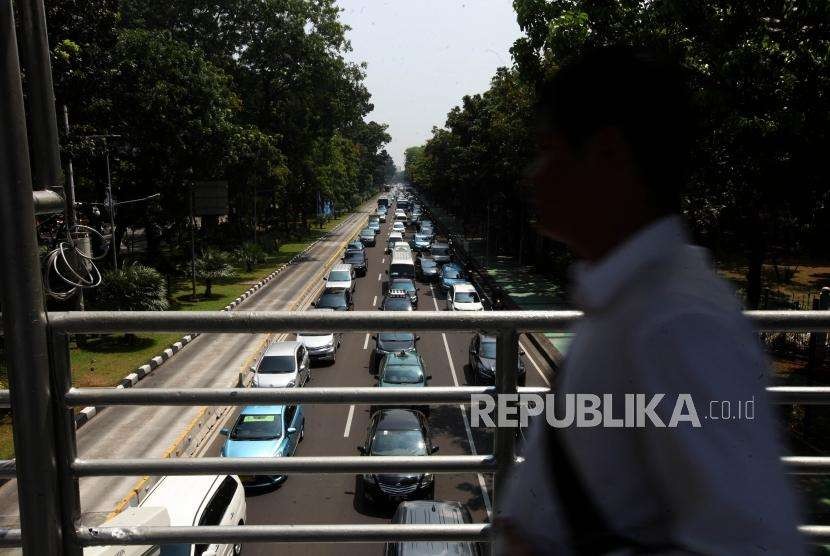 Antrean kendaraan yang melintas saat penerapan sistem ganjil genap di Jalan Medan Merdeka Barat, Jakarta, Senin (3/9).