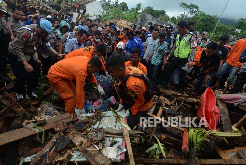 Sejumlah petugas gabungan mengevakuasi jenazah korban tsunami yang tertimbun reruntuhan bangunan di Desa Way Muli, Kalianda, Lampung Selatan, Senin (24/12).