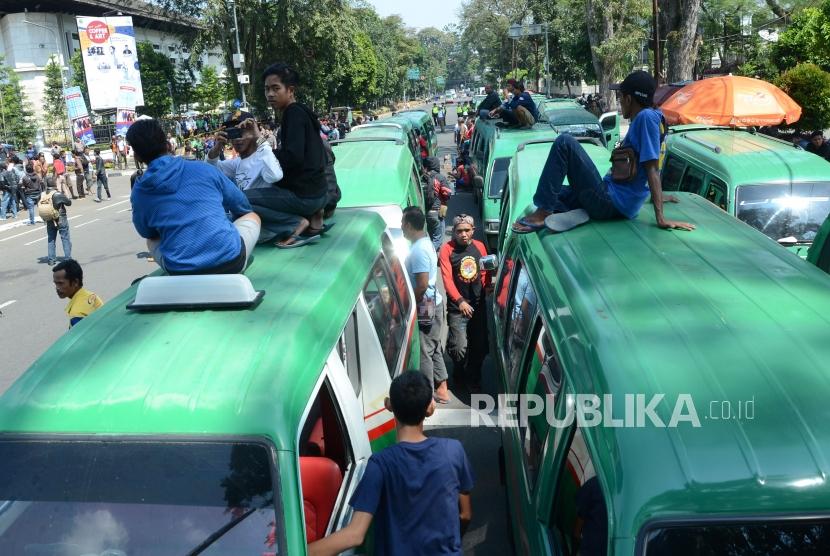 Puluhan angkot di parkir di depan Gedung Sate, Jalan Diponegoro, Kota Bandung saat unjuk rasa ratusan sopir angkutan kota (angkot) Selasa (8/5).