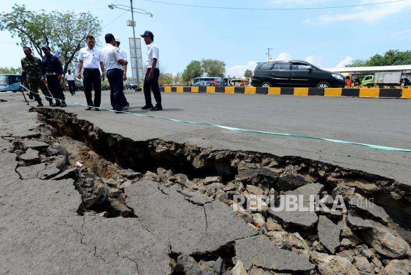 Petugas melihat kondisi area parkir ruang tunggu yang retak akibat gempa di Pelabuhan Kayangan, Lombok Timur, NTB, Selasa (21/8).