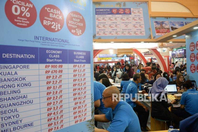 Pengunjung mencari info pemesanan tiket di salah satu stan pada Garuda Indonesia Travel Fair (GATF) phase II 2018 di Jakarta Convention Center, Jumat (5/10).