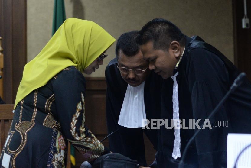 Mantan anggota DPR RI wakil ketua Komisi VII, Eni Maulani Saragih berdiskusi dengan penasehat hukum saat  menjalani sidang  perdana di Pengadilan Tindak Pidana Korupsi, Jakarta, Kamis (29/11).