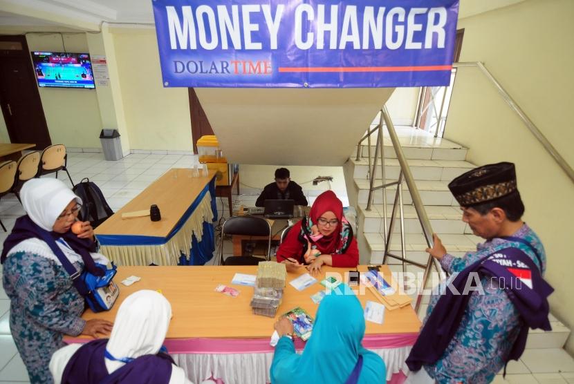 Petugas melayani penukaran mata uang Saudi Riyal untuk calon jamaah haji di Asrama Haji Pondok Gede, Jakarta, Senin (23/7).