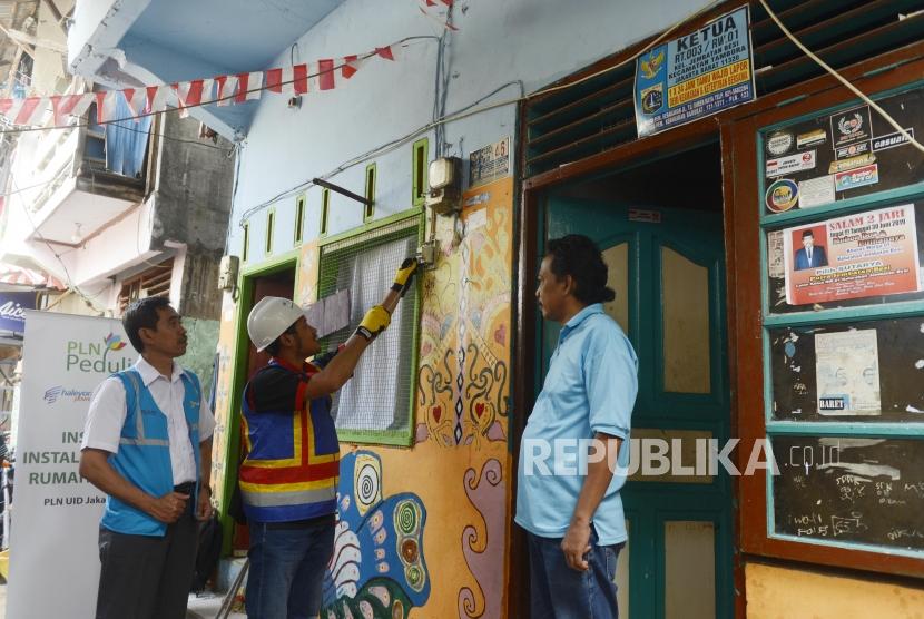 Petugas saat melakukan pemeriksaan instalasi jaringan listrik di pemukiman padat penduduk, Tambora, Jakarta Barat, Kamis (22/8).