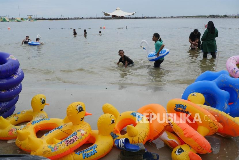Sejumlah anak bermain di pinggiran pantai Taman Impian Jaya Ancol Jakarta, Selasa (25/12).