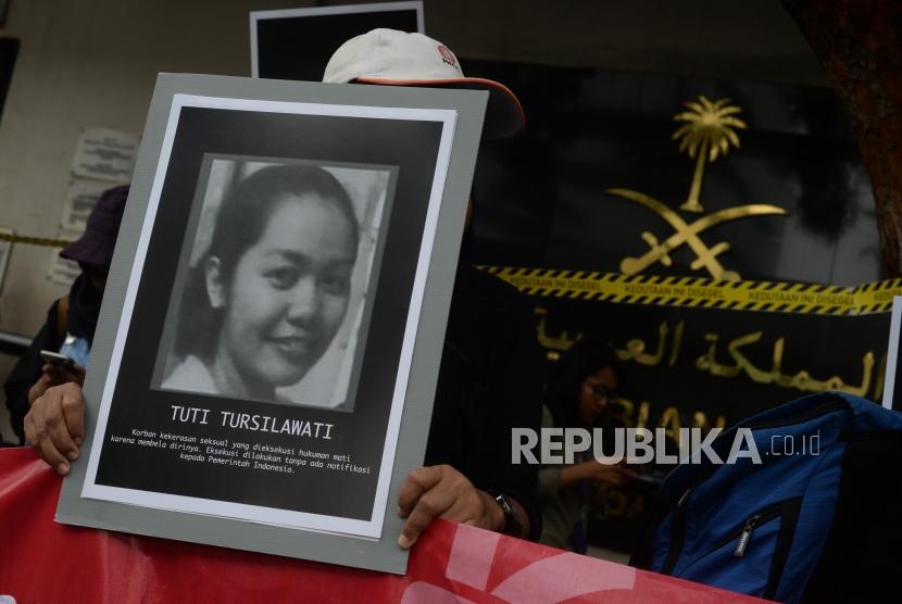 Massa unjuk rasa membawa foto  TKI Indonesia Tuti Tursilawati saat  unjuk rasa di depan Kedutaan Arab Saudi, di Jakarta, Jumat (11/2).