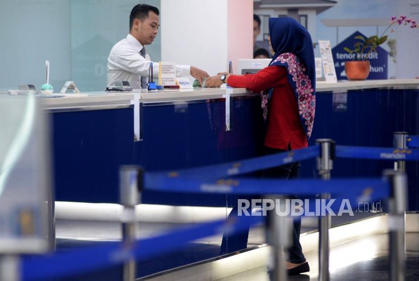 Petugas melayani nasabah ketika melakukan transaksi di Bank Mandiri, Kantor Cabang Plaza Mandiri, Jakarta. (ilustrasi)