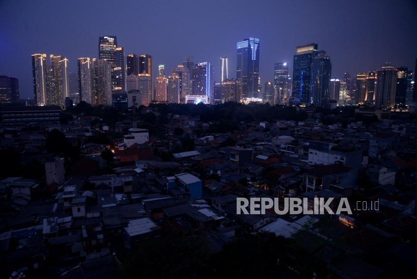 Suasana ketika terjadinya pemadaman listik di kawasan pemukiman padat penduduk Karet Tengsin, Jakarta, Ahad (4/8).