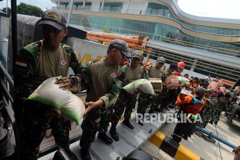 Sejumlah petugas gabungan beserta relawan mengangkut logistik ke KRI Torani 860 di Pelabuhan Bakauheni, Lampung Selatan, Jumat (28/12).