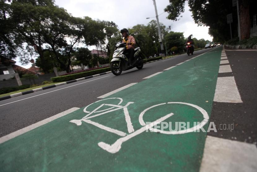 Kendaraan motor melintas disamping jalur sepeda kawasan Diponegoro, Jakarta, Selasa (20/2).