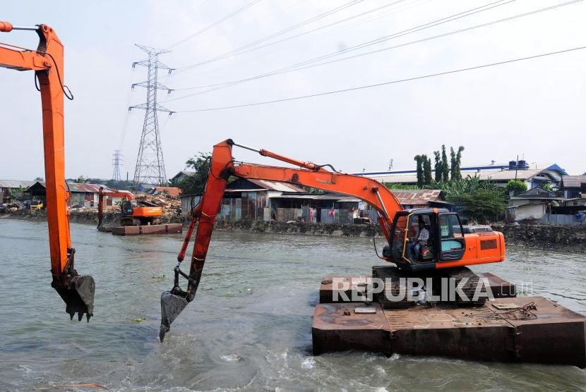 Petugas membersihkan sungai Kalimalang menggunakan alat berat di kawasan Cikarang, Bekasi, Jawa Barat, Kamis (12/7).