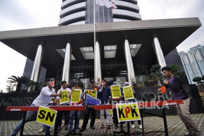 Sejumlah aktivis dari Koalisi Masyarakat Sipil Antikorupsi Indonesia mengenakan topeng wajah Ketua DPR Setya Novanto saat aksi teatrikal pertandingan tenis meja melawan KPK saat melakukan aksi di depan gedung KPK, Jakarta, Rabu (18/10).