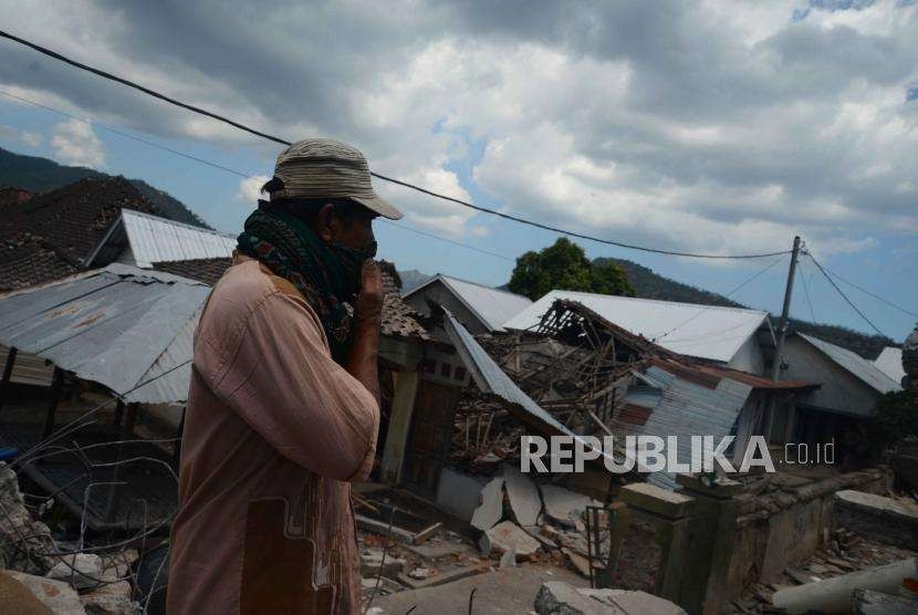 Warga melihat rumah yang rusak  akibat gempa, Desa Pemenang, Lombok Utara, NTB, Rabu (8/8).