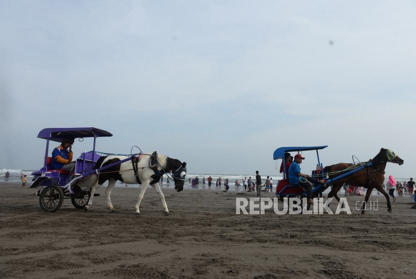 Lebaran di Pantai Parangtritis. Warga memadati kawasan wisata Pantai Parangtritis di Bantul, Yogyakarta, Jumat (7/6/2019).