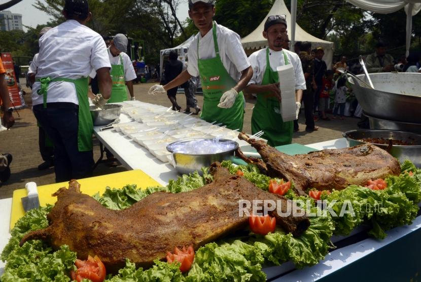 Juru masak menata daging kurban yang telah dimasak ke dalam wadah saat peluncuran Dapur Kurban di kawasan Monas, Jakarta, Senin (12/8).