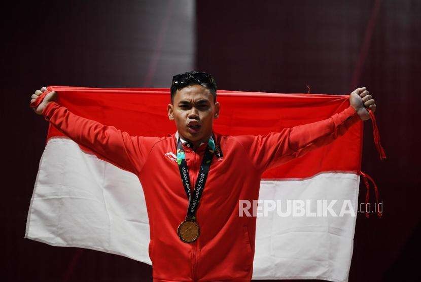  Selebrasi Lifter Indonesia  Eko Yuli  Irawan  usai  memenangkan medali  emas di cabang angkat besi putra nomor 62 Kg Asian Games 2018 di Hall A Kemayoran, Jakarta, selasa (21/8).